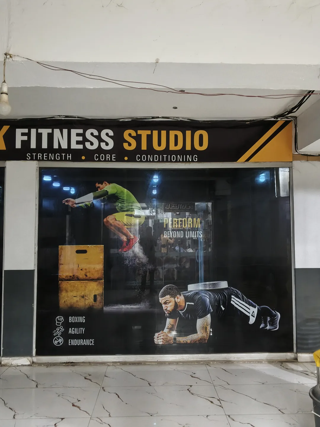 Right storefront window with printed fitness graphics