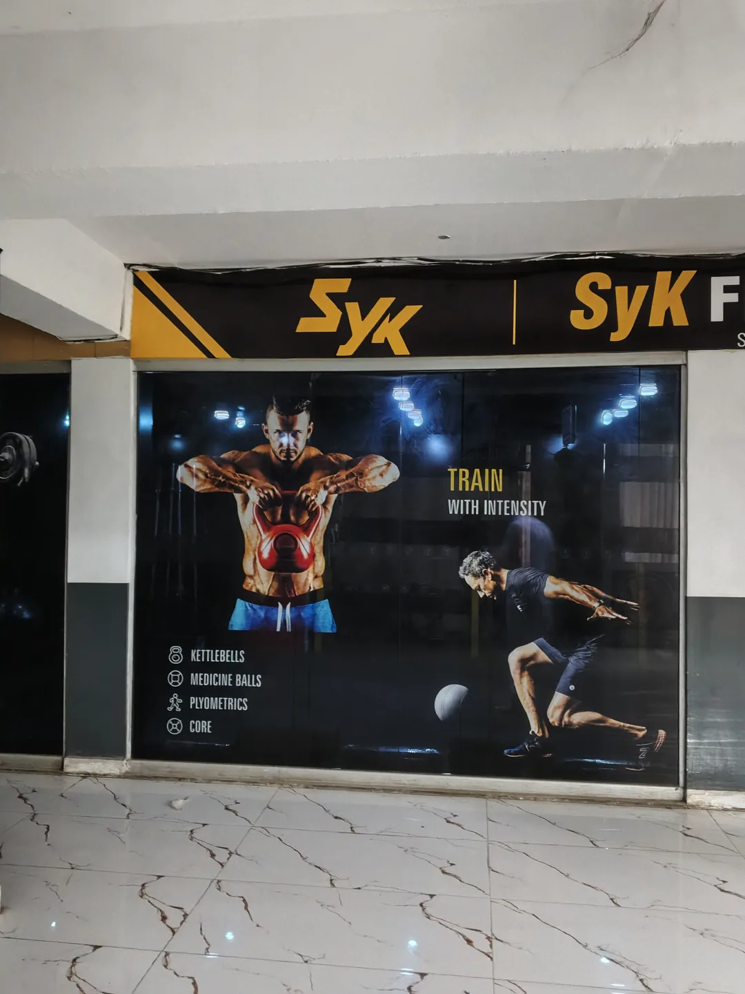 Left storefront window with printed training graphics